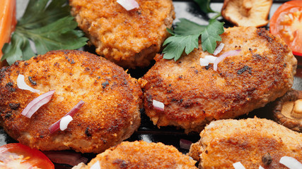 Homemade cutlets with fresh vegetables and herbs close up