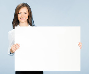 Businesswoman showing signboard, over blue