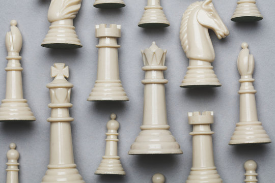 Chess game pieces on a grey background. Strategy concept