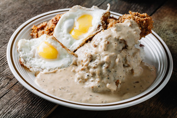 Eggs with grits and country fried chicken