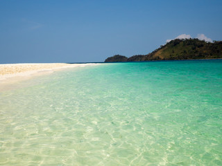 Crystal turquoise green sea ocean clear water and mountain at Lipe Island, Satun, Thailand.