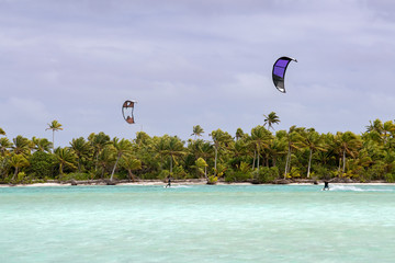 kite surfers on tropical polynesian beach aitutaki cook islands