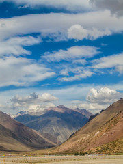 Andes mountains landscape with beautiful blue sky and scenic clouds