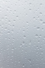Light rain on the window glass, grainy texture on background