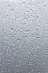 Light rain on the window glass, grainy texture on background