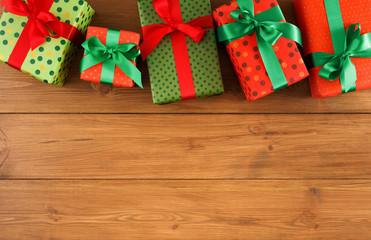 Fototapeta na wymiar Colorful present boxes for any holiday on wooden background