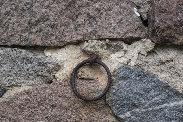 trapped in a stone wall, corroded ring