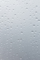 Light rain on the window glass, grainy texture on background