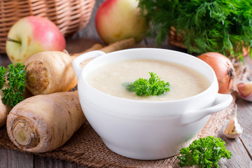 Vegetable soup puree with vegetables on a wooden table