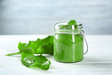 Jar of spinach smoothie on table