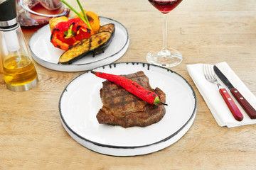 Delicious steak served with chili pepper on plate