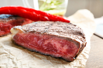 Cut rare steak on paper, closeup