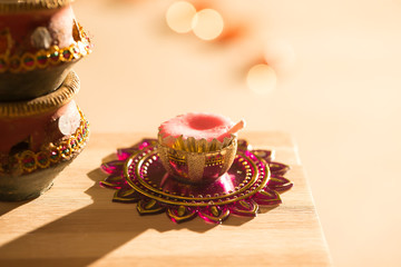 diwali lights placed nearby diyas in low light