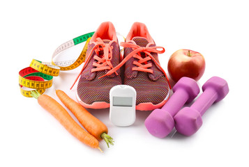 Composition with digital glucometer and sport inventory on white background. Diabetes concept