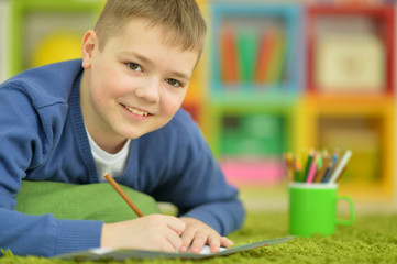 little boy drawing with pencil