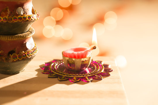 diwali lights placed nearby diyas in low light