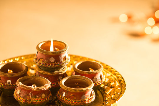 diwali lights placed nearby diyas in low light