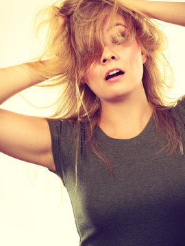 Crazy, mad blonde woman with messy hair