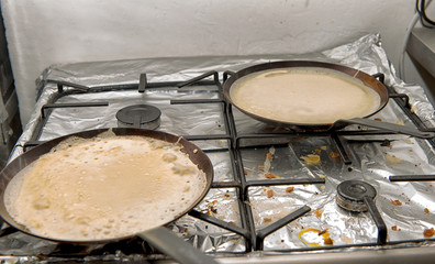 Making pancakes on frying pans