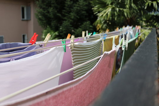 Wet Clothes Hanging On A Balcony