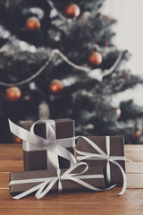 Christmas presents on decorated tree background, holiday concept