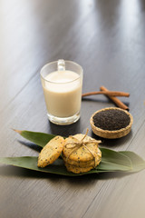 Sesame Cookies, sesame and milk on black wooden background