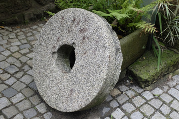 old, massive millstone leaned on