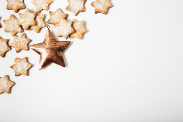 Fototapeta na wymiar Christmas frame.gingerbread stars with golden metal star.Christmas decoration.White background.