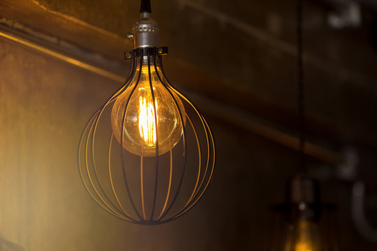 Decorative antique edison style light bulbs against brick wall background