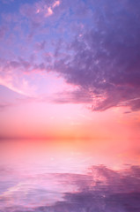 Naklejka premium A pink sunset on a summer sky over the sea.