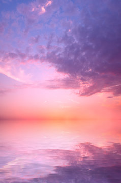 A pink sunset on a summer sky over the sea.