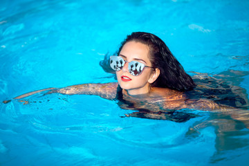 Vacation.Beautiful young woman at a pool