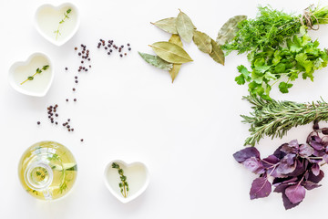 greenery with natural oil for cooking on white kitchen table background top view mock-up