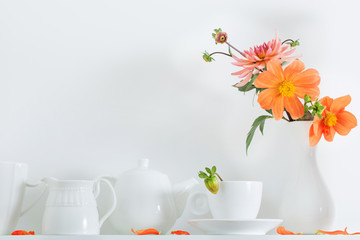 white dishvare with flowers on wooden shelf