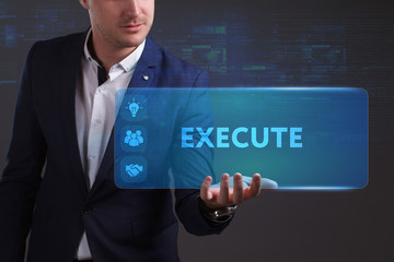 Business, Technology, Internet and network concept. Young businessman working on a virtual screen of the future and sees the inscription: Execute