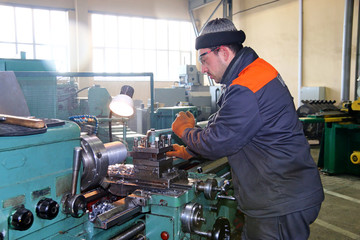 The milling-machine operator works at the lathe