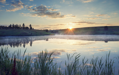 Summer landscape with river.Sunrise.Magic atmosphere.Fog over the water.River Krasivaya in Tula region,Russia. 