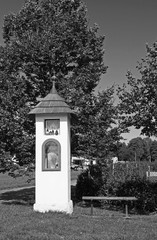 Fototapeta na wymiar black and white photo of a nice white calvary monument in Dobra, Czech Republic