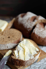 piece of black bread   with butter made with rye and wheat flours