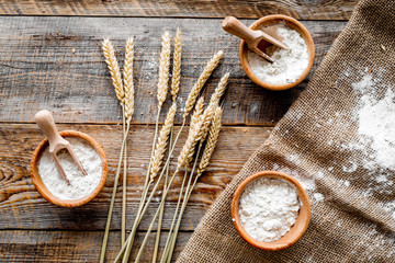 wheat and rye ear for flour production on wooden desk background top view