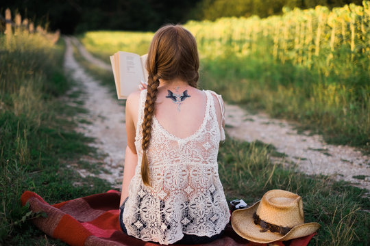 Anonymous Woman Reading a Book in Nature