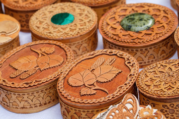 Handicrafts made of birch bark. Various carved boxes on the traditional town fair.