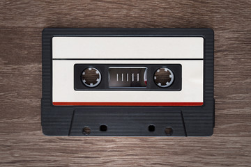 Fototapeta premium Vintage audio cassette tape on brown wooden background