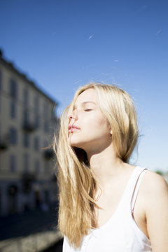 Portrait of blond candid girl with closed eyes