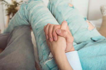 Man and woman holding each other's hands