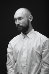 young white beard man white shirt black pants studio monochrome background