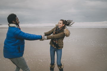 Young Couple Dance On A Winter Beach