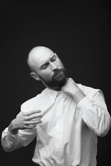 young white beard man white shirt black pants studio monochrome background