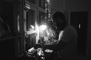 Silhouette of a man playing vinyl at home