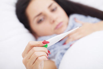 Fever And Cold. Portrait Of Beautiful Woman Caught Flu, Having Headache And High Temperature. Closeup Of Ill Girl Covered In Blanket, Feeling Sick Holding Thermometer. Health care. High Resolution